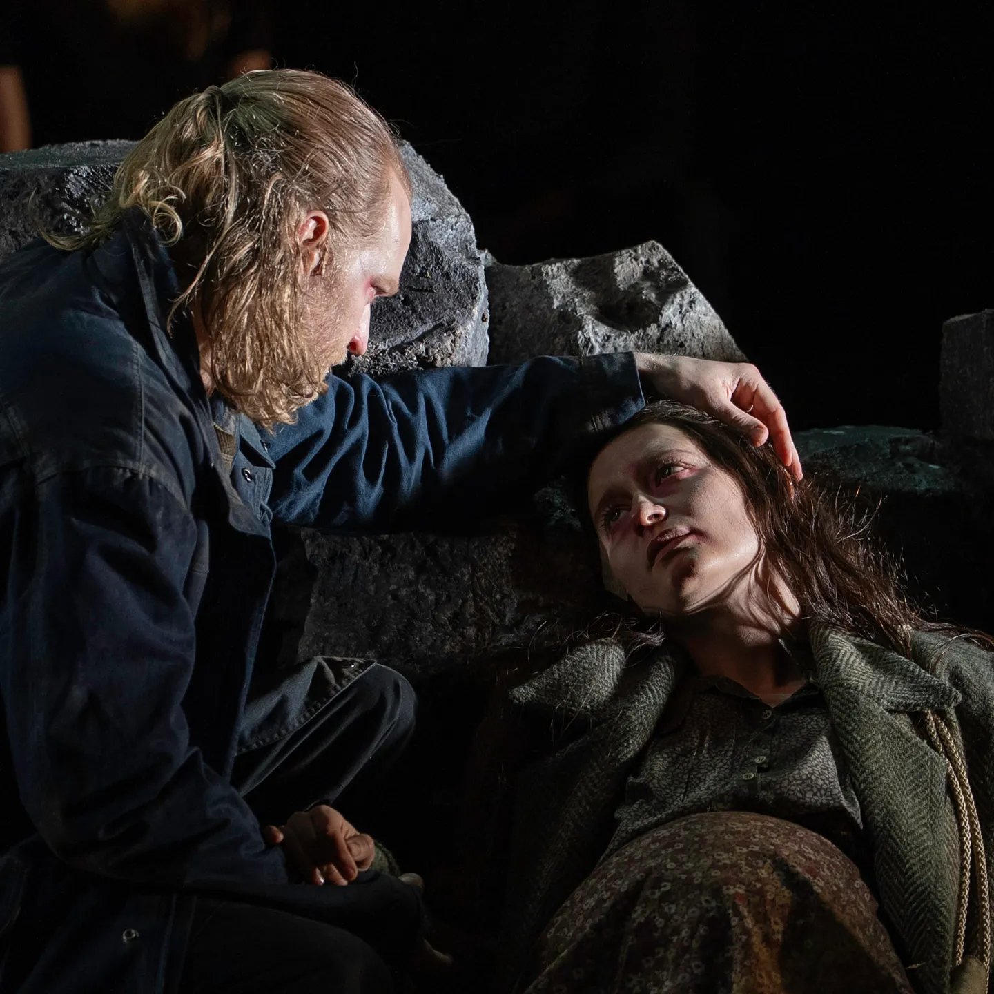 Two opera performers in a dramatic scene on stage.